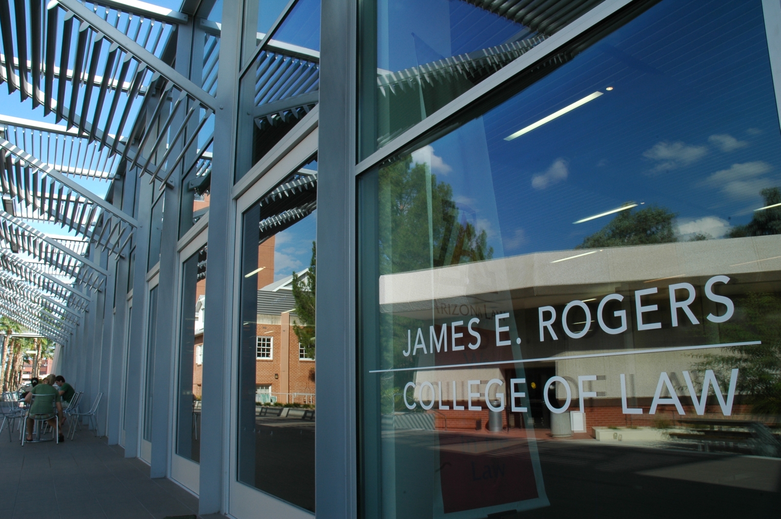 James E. Rogers College of Law sign on the glass window of the exterior of the University of Arizona Law building