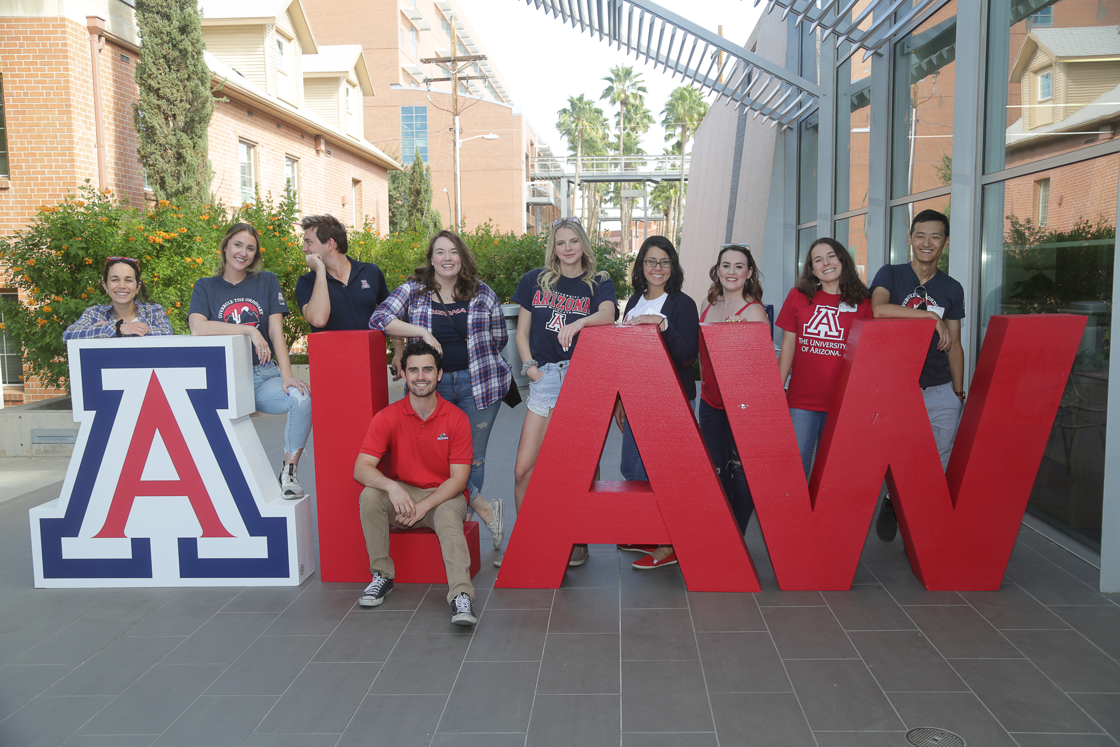 Students posing around A LAW large letters 