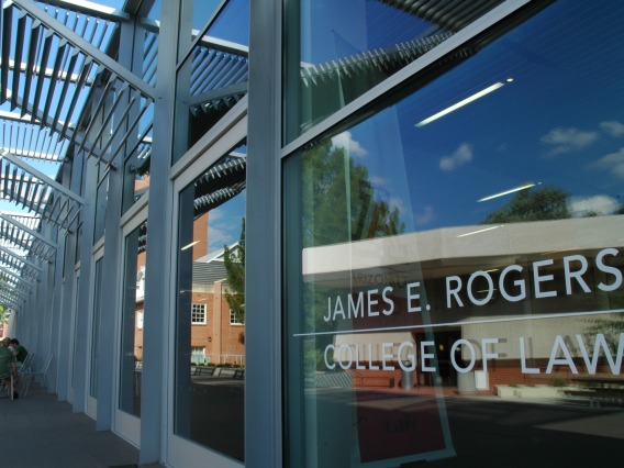 James E. Rogers College of Law sign on the glass window of the exterior of the University of Arizona Law building