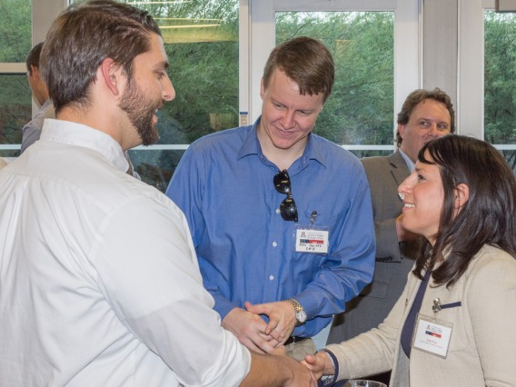 Career Development Office counselor shakes hands with student at career mixer event