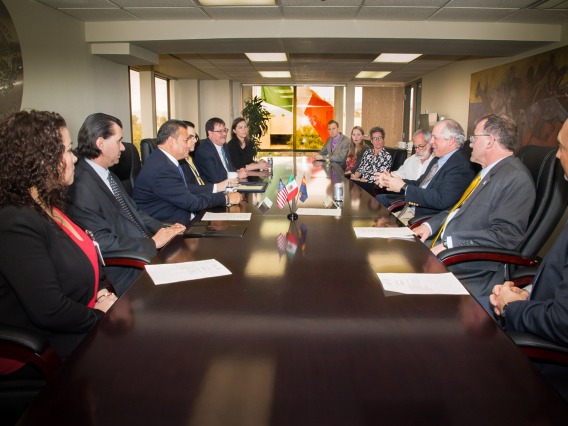 Leaders from the Mexican Foreign Ministry, the University of Arizona and the James E. Rogers College of Law sit around a table to sign a partnership agreement to teach law to Mexican diplomats