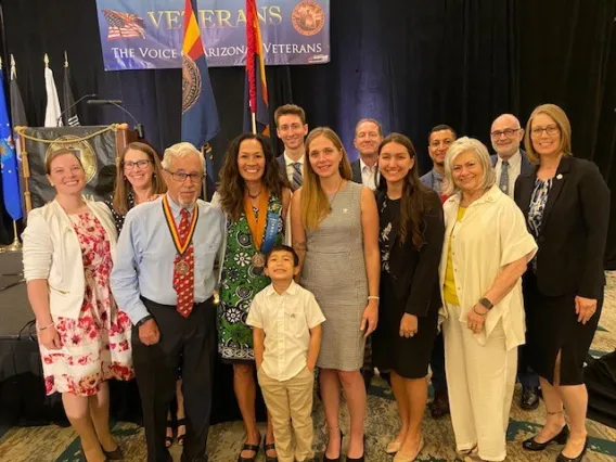 Kristine Huskey surrounded with current and former students, professors and family after receiving award