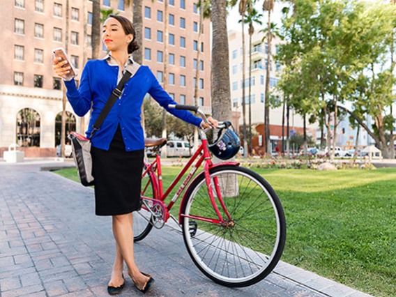 Woman with bike and cell phone