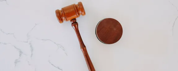 wooden gavel on white surface