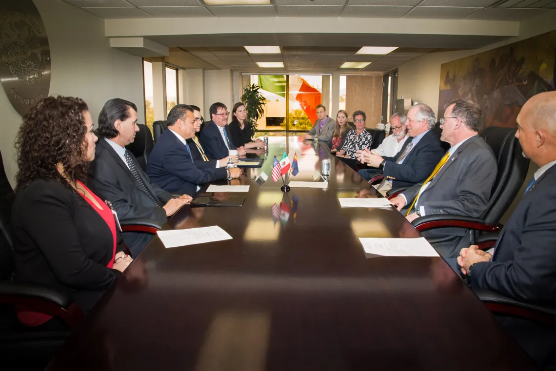 Leaders from the Mexican Foreign Ministry, the University of Arizona and the James E. Rogers College of Law sit around a table to sign a partnership agreement to teach law to Mexican diplomats