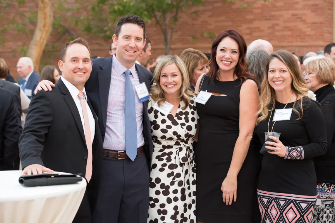 Five people gathered at an outdoor reception