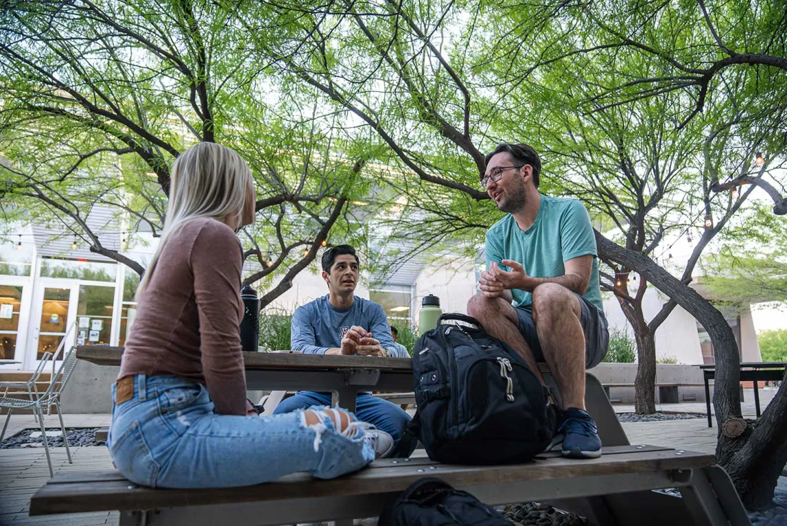 Group of students sitting at picnic table