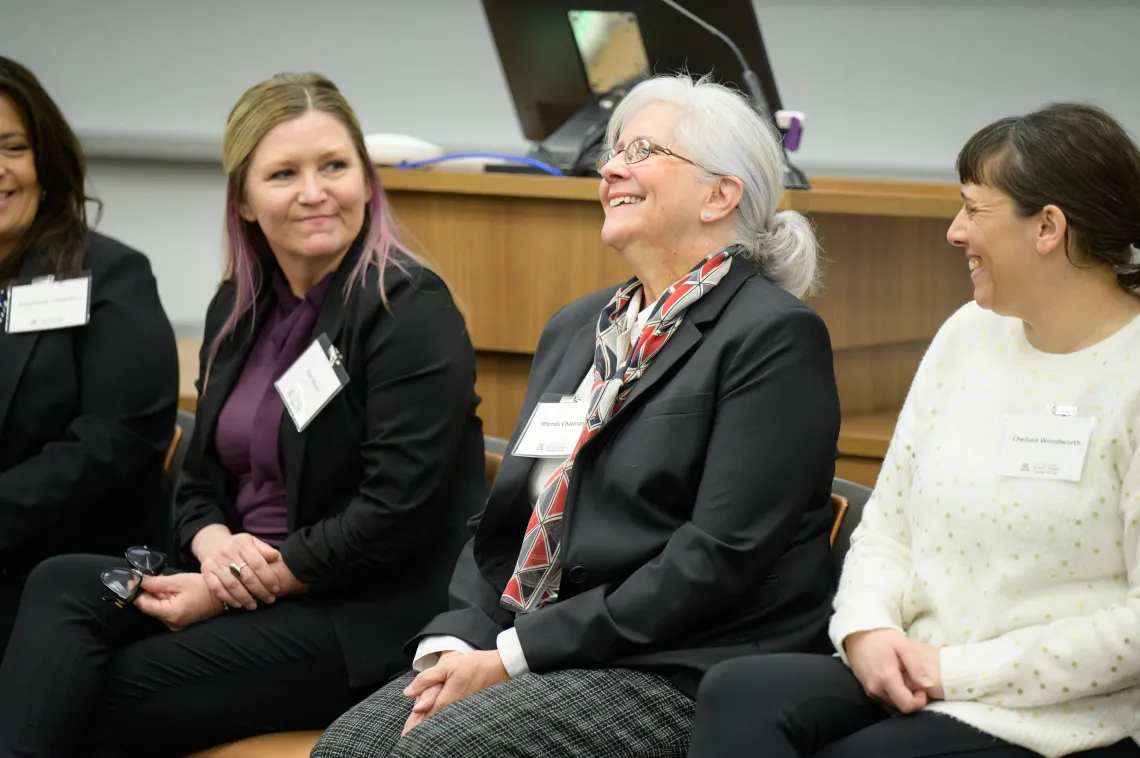 Three women laughing and chatting at the LP Summit