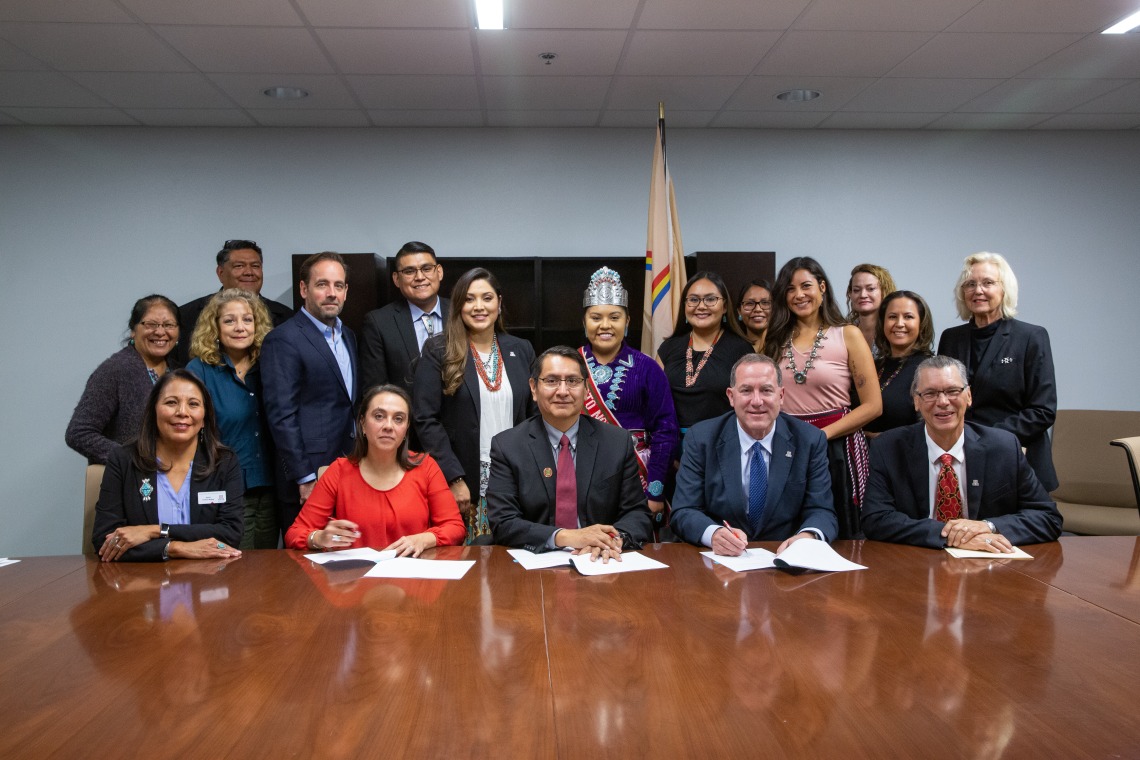Representatives from the University of Arizona and the Navajo Nation gathered in a group to sign a memorandum of agreement establishing a new fellowship program