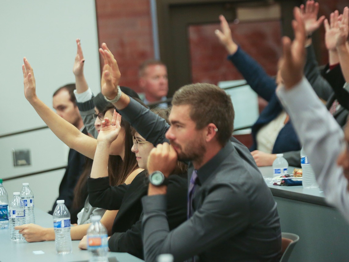 University of Arizona Law students raise their hands during a class