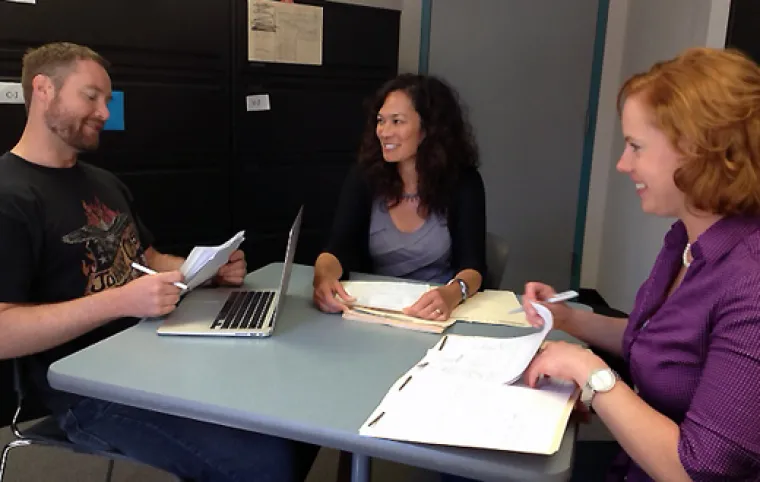 People review papers around a table