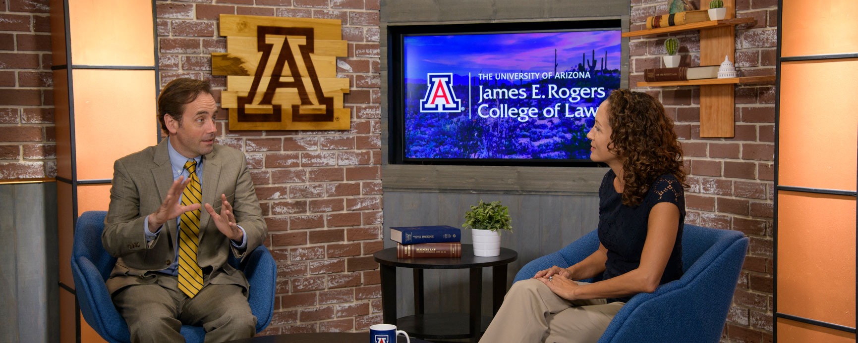 University of Arizona Law professors Christopher Robertson and Stacy Butler talking on a studio set
