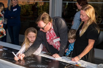 Alumni Kevin Boyle and his family signing. Boyle contributed a $1 million lead gift to "A New Day in Court”, establishing the Kevin R. Boyle Courtroom, currently under construction.